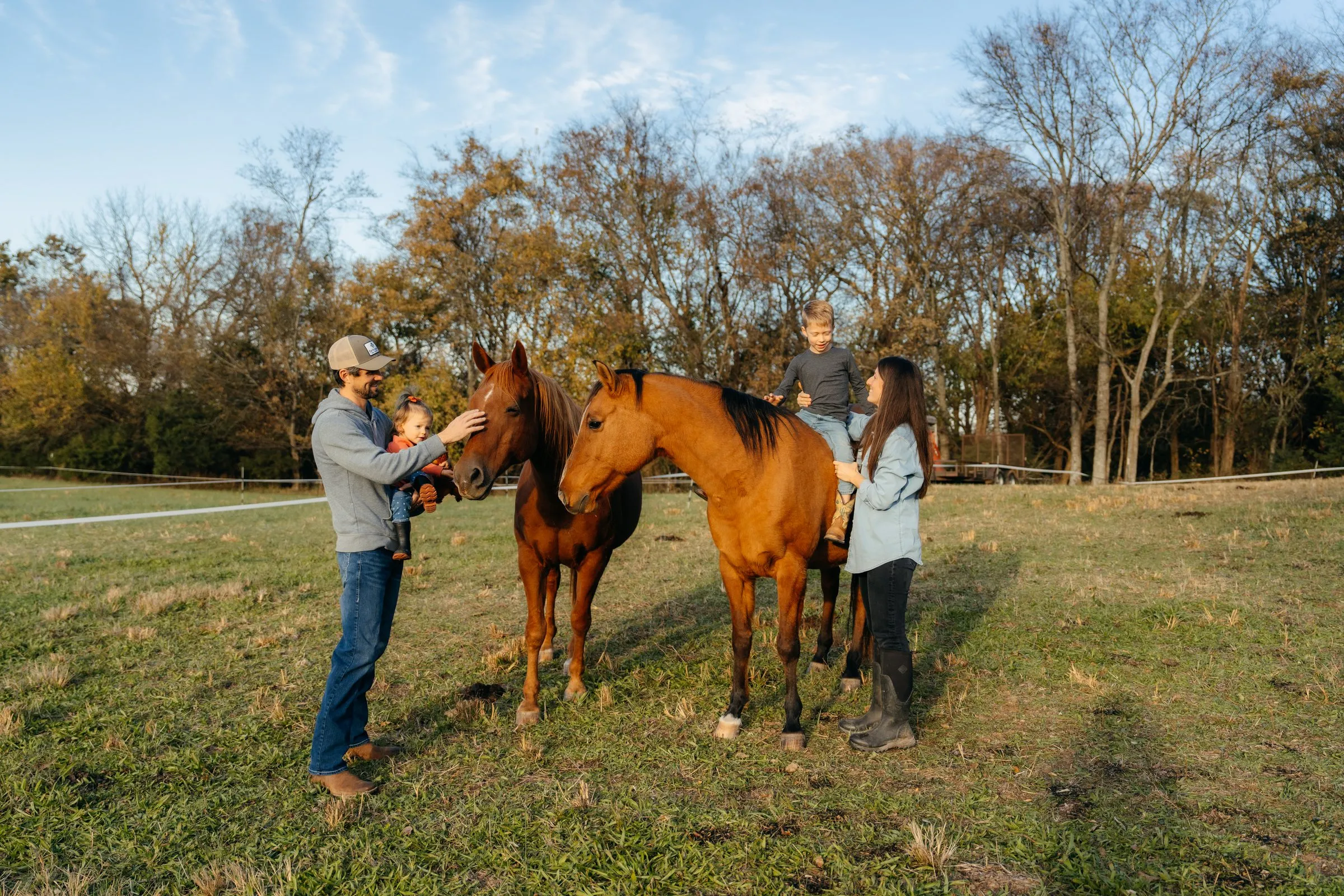 The family with their two horses in the field