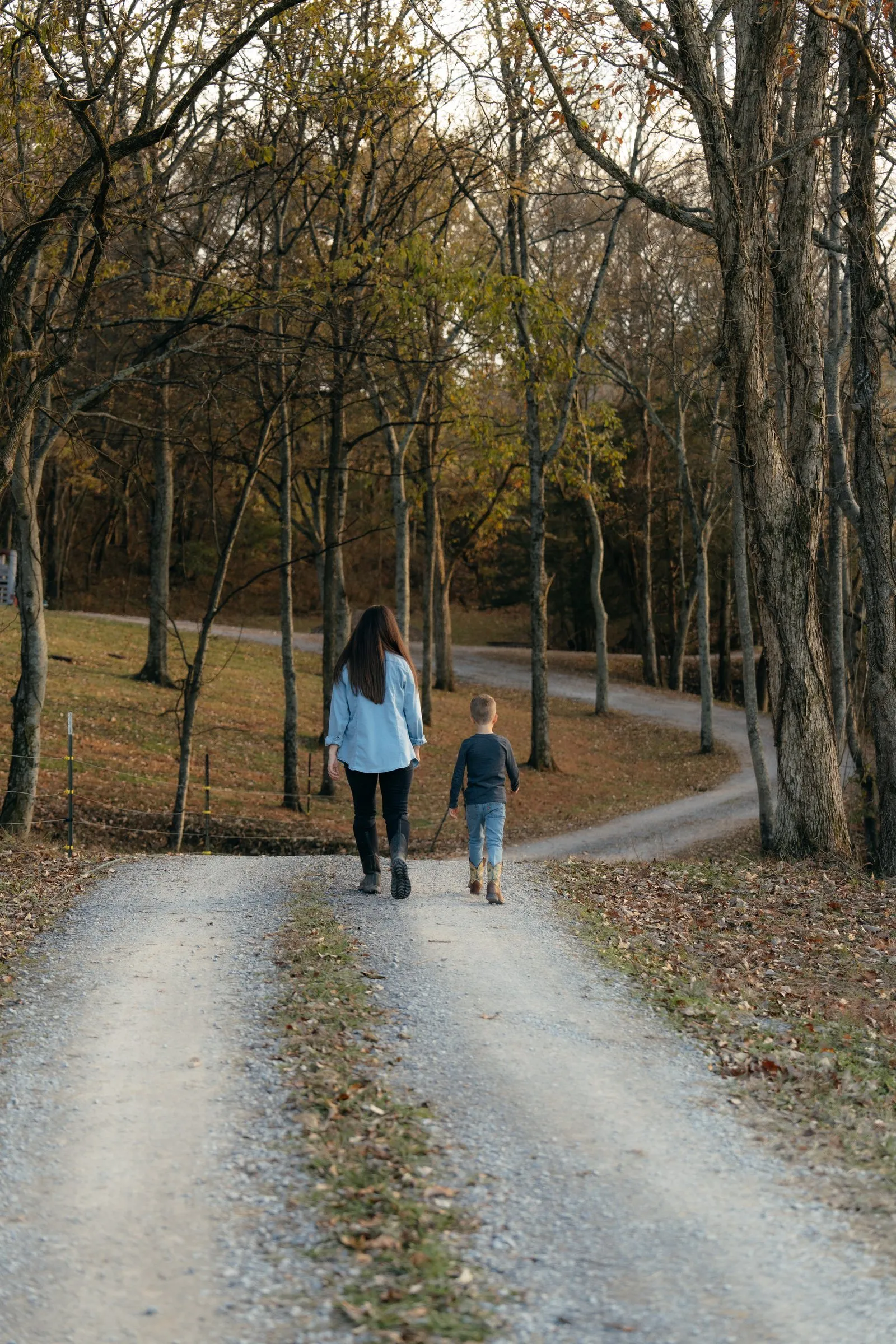Sarah and son walking down the tree-lined lane
