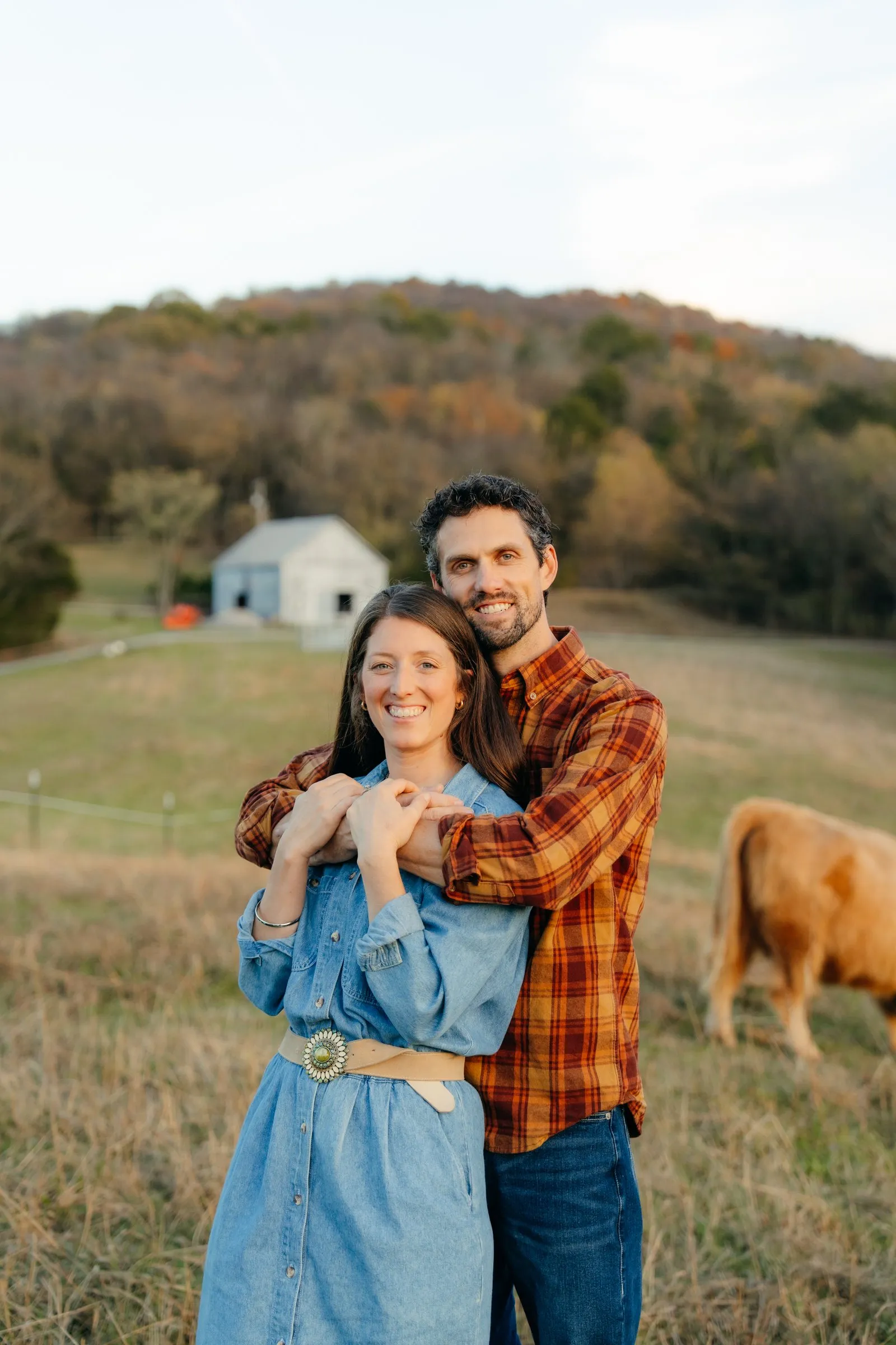 Rhett and Sarah Fast laughing together in their pasture